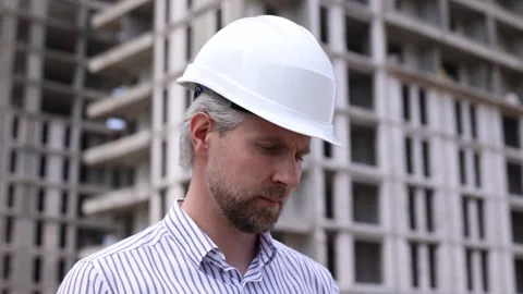 Engineer man in helmet use tablet computer for controls construction Stock Footage 340068106