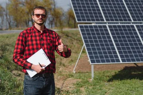 Engineer. Man near solar panel. Worker with a folder. Stock Photos
