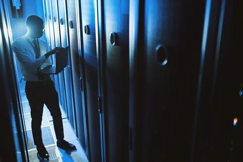 Engineer, man or laptop in server room at night for cybersecurity, software.. Stock Photos