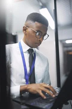 Engineer, man or typing on laptop in server room for cybersecurity, softwar.. Stock Photos