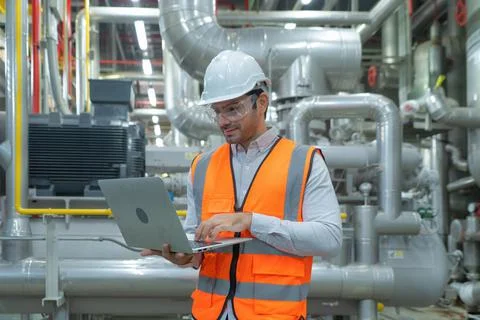 An engineer man or worker, people using a laptop computer, working in industr Foto stock