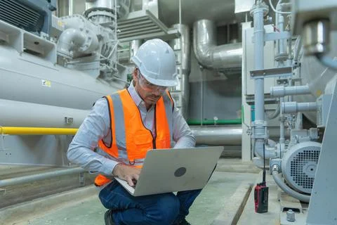 An engineer man or worker, people using a laptop computer, working in industr Stock Photos