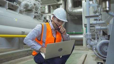 An engineer man or worker, people using a laptop computer, working in industr Stock Photos