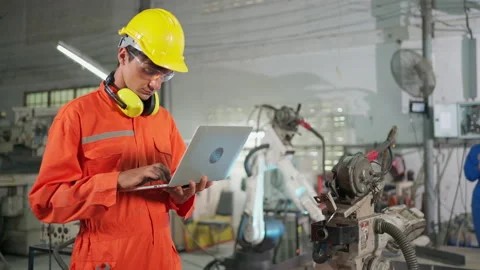 Engineer man setup program for robotic arm machine Stock Footage 153075313