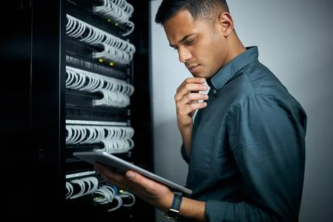 Engineer man, tablet and thinking in server room inspection, coding and check Stock Photos