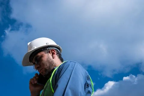 Engineer man talking on his phone in sunny day Stock Photos
