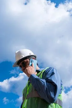 Engineer man talking on his phone in sunny day Stock Photos
