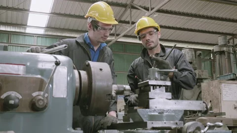 Engineer man training with foreman for apprentice using lathe, apprenticeship Stock Footage 138891299