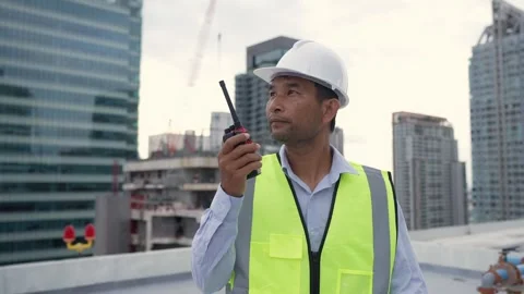 Engineer man wearing a yellow safety vest is walking on a rooftop. The man .. Stock-Footage 280732586