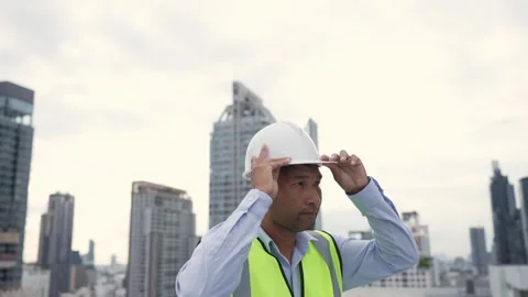 Engineer man wearing a yellow vest and a white hard hat. Stock-Footage 280732580