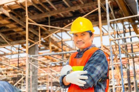 Engineer man / worker at construction site with arms crossed Fotos Stock