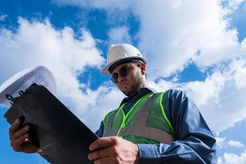 Engineer man working and looking documents in sunny day Stock Photos