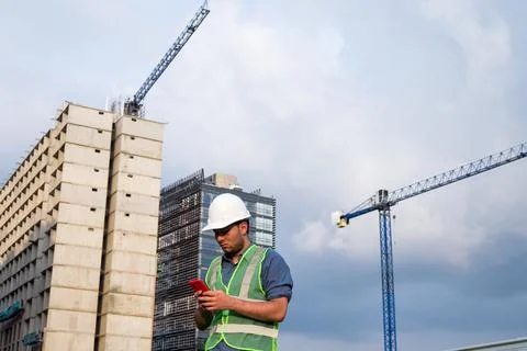 Engineer man working on his phone in construction site Stock Photos