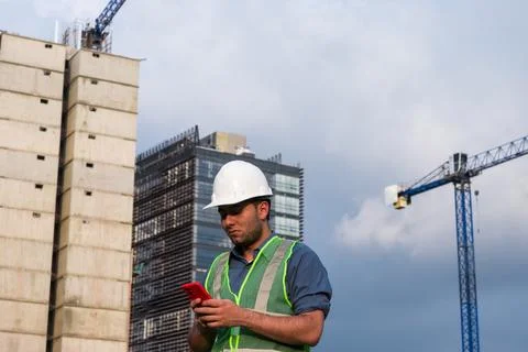 Engineer man working on his phone in construction site Foto stock