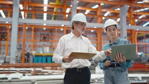 Engineer manager holding laptop talking and standing at manufacturing factory Stock-Footage 237008992