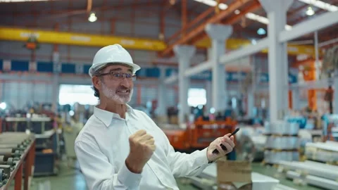 Engineer manager leader man typing on smartphone hands up to celebrate success Stock-Footage 237008496