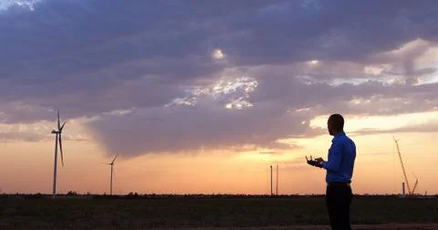 An engineer manages the construction of wind generators  Stock Photos