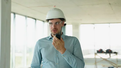 Engineer managing construction with radio and laptop Stock Footage 285673656