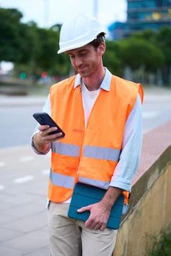 Engineer managing construction site work with digital devices 写真素材