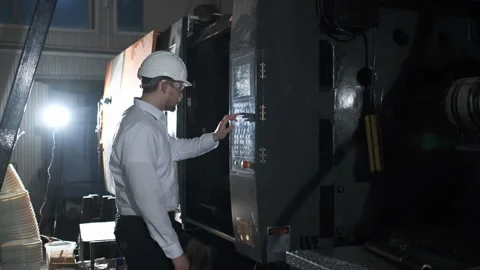 An engineer is managing plastic-making equipment through control board Stock Footage 114505507
