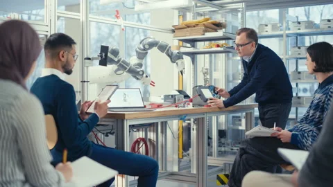 Engineer Manipulate With Robot Arm And Talk Video stock 187583834