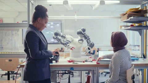 Engineer Manipulating Robot Arm With Controller Video stock 187582176