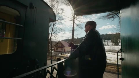 Engineer manually brakes the Mocanita train in Romanian villages during daylight Stock Footage 346718420