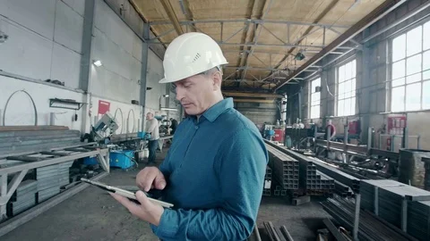 The engineer on manufacture with a tablet Stock Footage 80361839