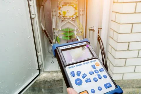 The engineer  measures the level of the optical signal. A technician diagnose Stock Photos