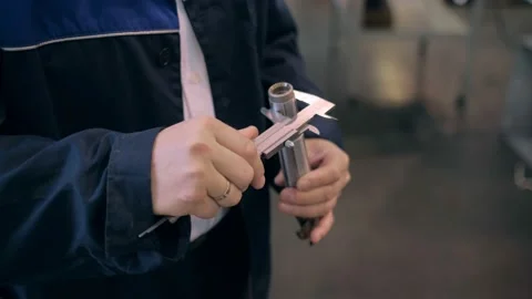 The engineer measures the part with a caliper. A tool manufacturing plant. Stock Footage 172112758