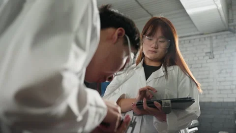 Engineer Measuring Engine Dimensions While Colleague Records Data on Tablet Video stock 301247281