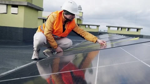 Engineer measuring solar panels on rooftop. Stock Footage 331299342