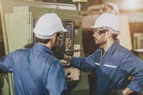 Engineer mechanic team staff worker training operate lathe milling CNC mach.. Stock Photos