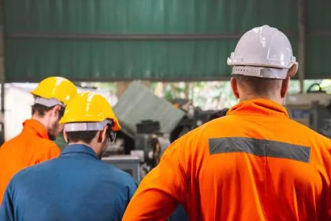 Engineer with mechanical worker  checking on production in a factory. Stock Photos