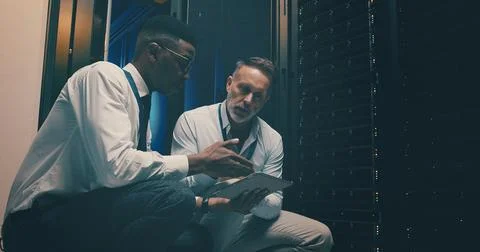 Engineer, men and teamwork with tablet, server room and planning for software Stock Photos