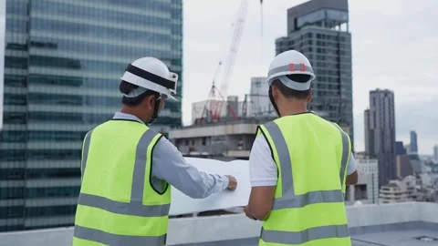 Engineer men discuss working on rooftop Stock Footage 280732552