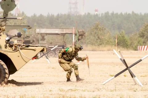 Engineer with mine detector move and make a pass Stock Photos