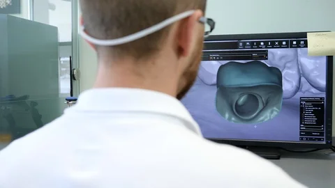 Engineer models implant teeth for customers, bearded guy into 3D glasses sitting Stock Footage 87178185