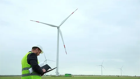 The engineer monitors the wind turbines Stock Footage 91373435