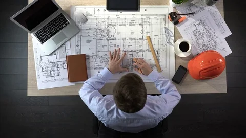 Engineer nervously checking drawings before beginning of building construction Stock Footage