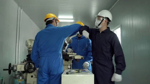 Engineer a new greeting to Foreman by bumping elbows. Stock-Footage 140213072