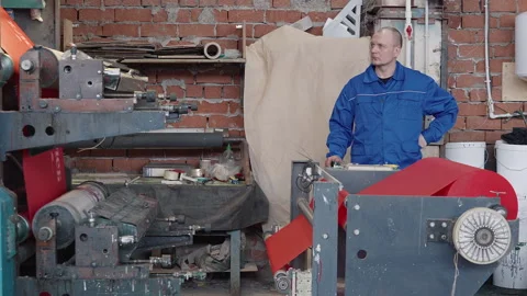 Engineer Observes Textile Processing By Automated Machine Rolling Fabric Stock Footage 245707395