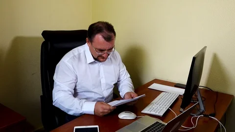 An engineer in the office is looking at project documentation Stock Footage 115232692