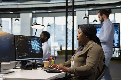 Engineer in office trains machine learning models for anomaly detection Stock Photos