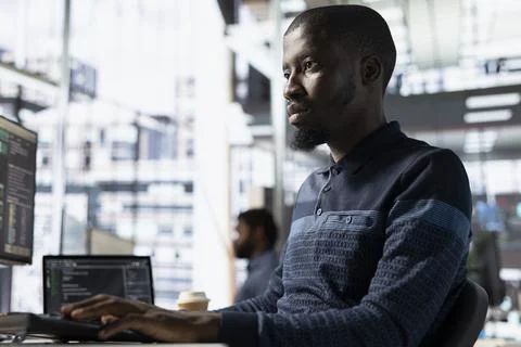 Engineer in office utilizing cloud computing resources Stockfoto's
