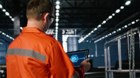 Engineer operates artificial intelligence tools on tablet in manufacturing plant Video stock 321910843