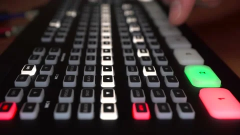 An engineer operates a digital video mixer. A man switches buttons on the camera Stock Footage 233331986