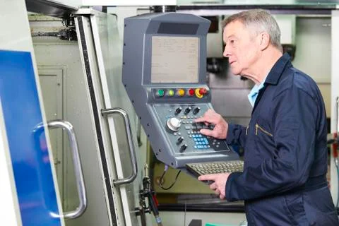 Engineer Operating Computer Controlled Cutting Machine Stock Photos