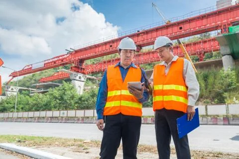 Engineer or Architect consult over Digital Tablet to supervise or manage Moto Stock Photos