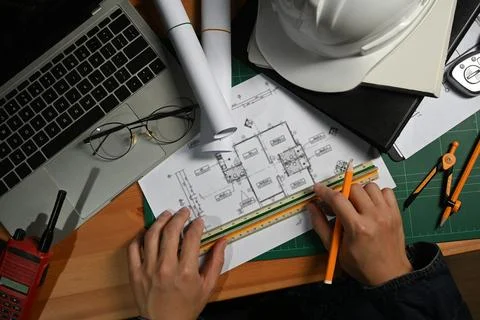 Engineer or architect man working with blueprints, planning development details Stock Photos